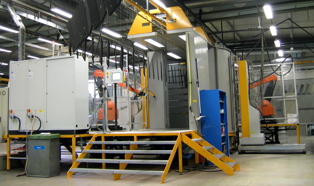 In the photo: a powder coating booth with automatic robotic manipulators (ABB + GEMA)