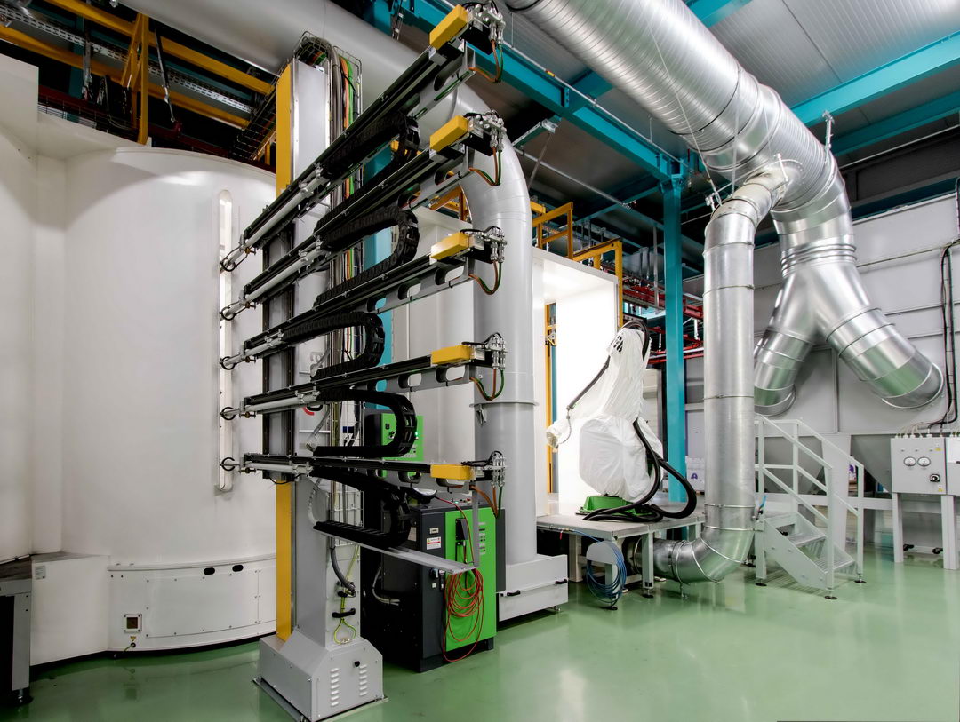 In the photo: a powder coating booth with automatic reciprocators and robotic manipulators equipped with GEMA spray guns