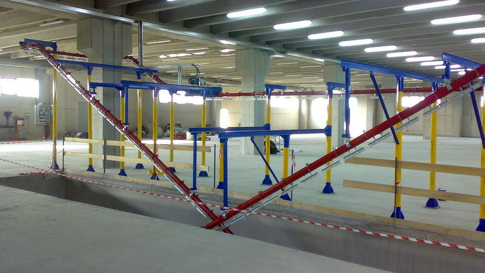 Photo of a conveyor on different floors of a production facility